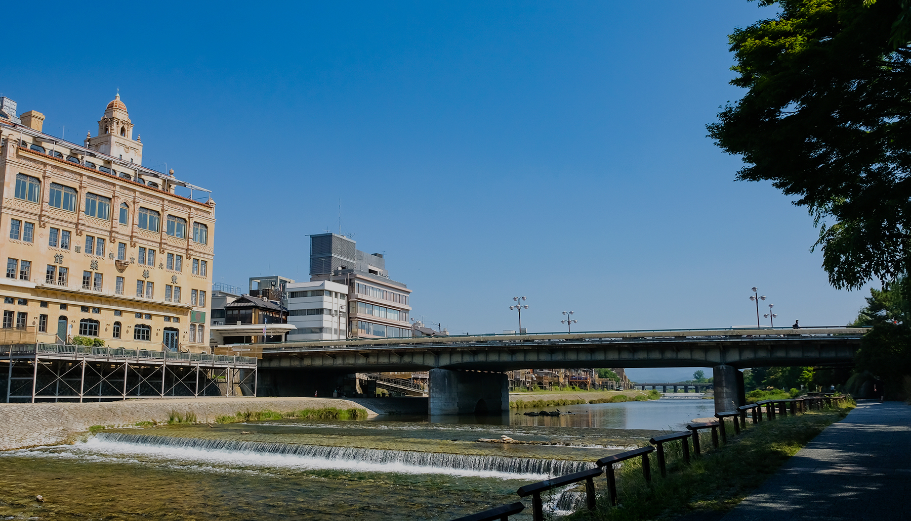 View of the Kamo River and a historical Western-style building on its banks.