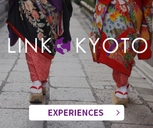 A close-up of feet in elegant kimonos walking through the streets of Kyoto. The banner for English-speaking markets features the LINK KYOTO logo in the center and an EXPERIENCES button at the bottom.
